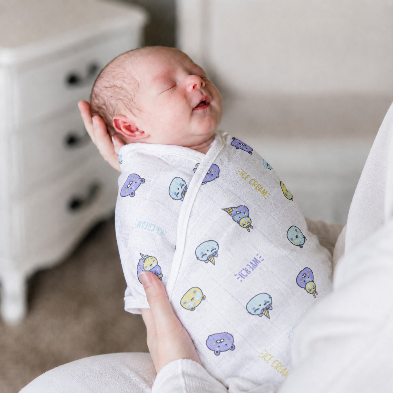 Soft breathable Boon Babies muslin swaddle blanket with printed design, measuring 100x100 cm, ideal for gentle baby wrapping.