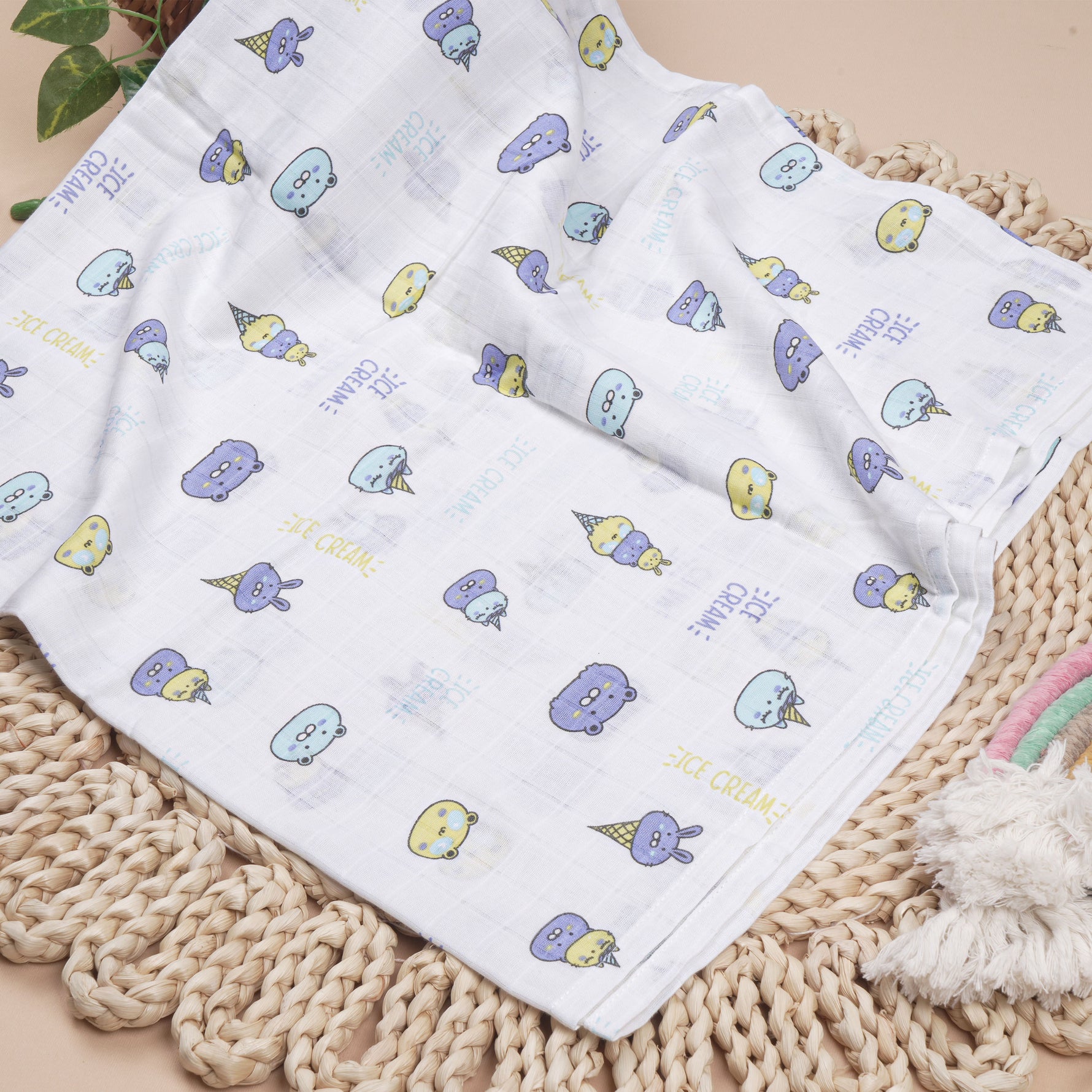 Soft, breathable Boon Babies muslin swaddle blanket with colorful printed design, measuring 100x100 cm, used as a baby swaddle wrap.