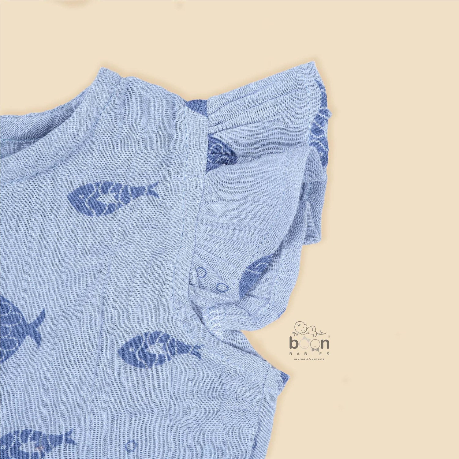 Baby romper in soft blue crinkled muslin with navy fish prints and snap buttons – perfect for 0 to 12 months, from Boon Babies, Coimbatore.