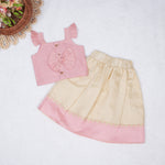 Blush pink embroidered cotton top with cream skirt, elastic waist and lining – elegant Kerala-style ethnic wear for girls aged 1–5 years.