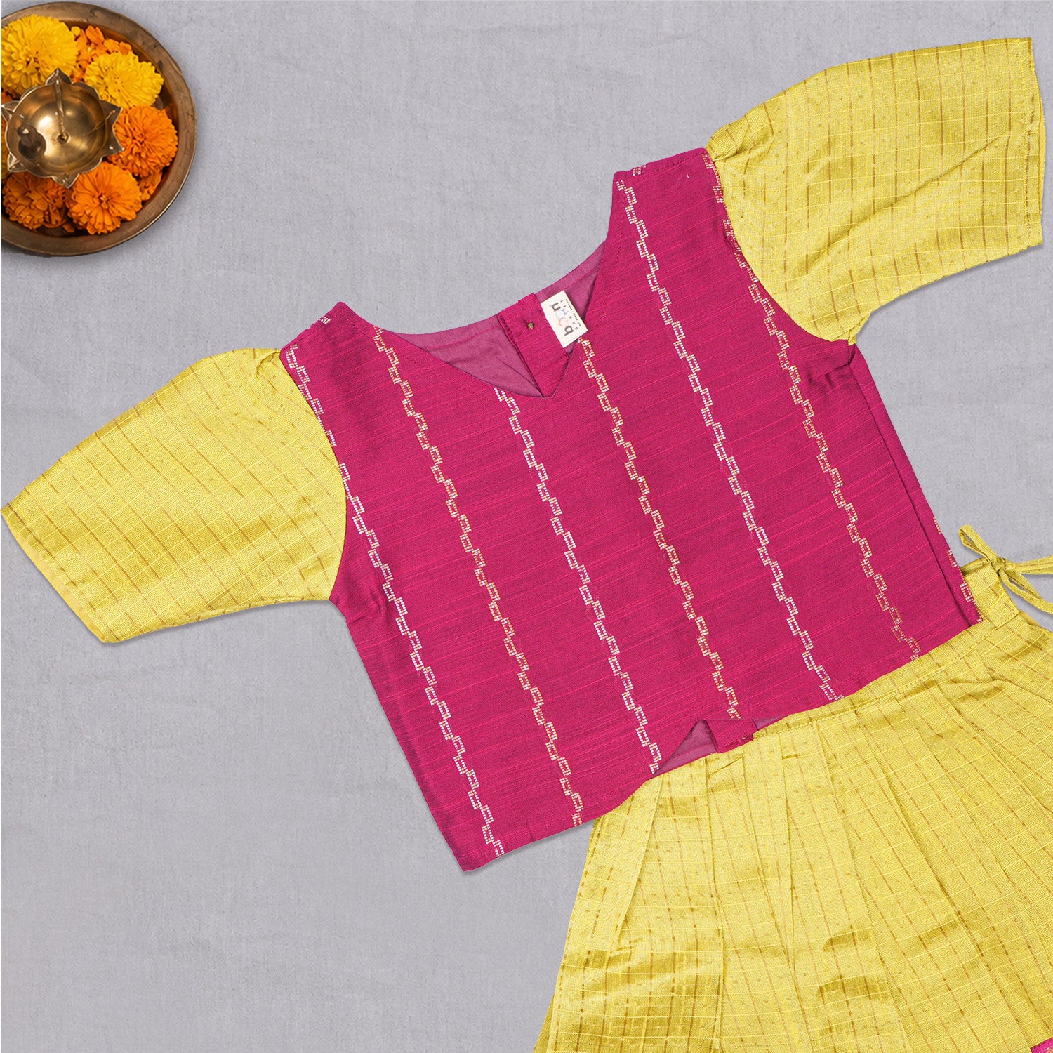 Girls ethnic top and skirt set in raw silk by Boon Babies, featuring vibrant traditional patterns and soft, luxurious fabric.