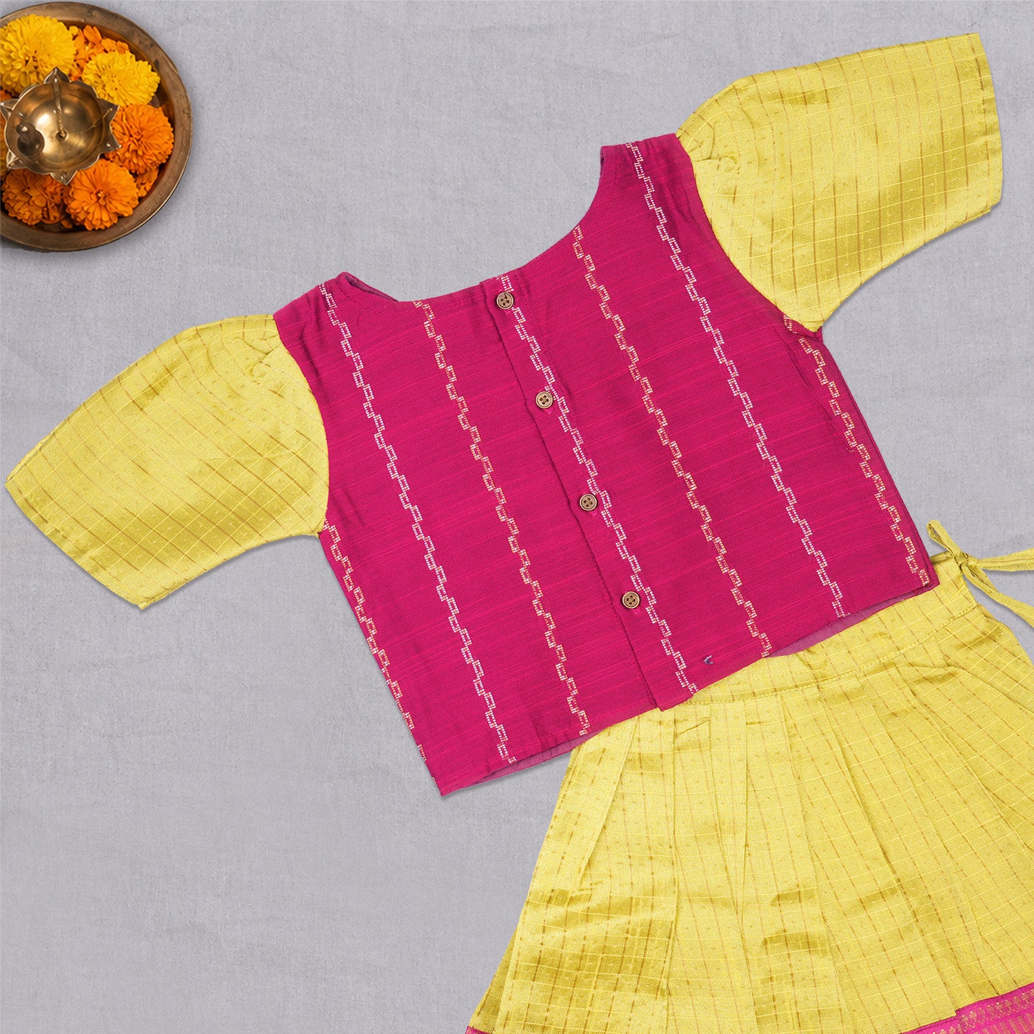 Girls ethnic top and skirt set in raw silk by Boon Babies, featuring traditional design and vibrant fabric details.