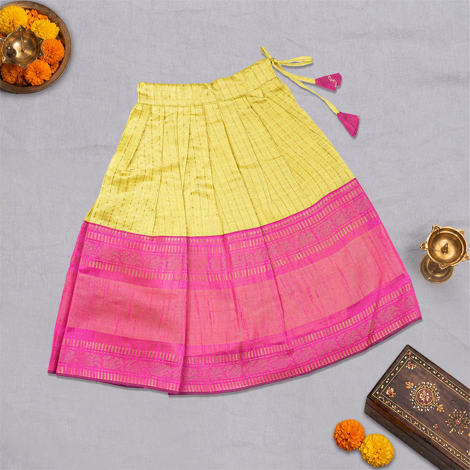 Girls ethnic top and skirt set in raw silk by Boon Babies, featuring vibrant traditional patterns and elegant fabric details.