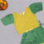 Girls green ethnic top and skirt set with cotton lining from Boon Babies, featuring traditional patterns and comfortable fabric.