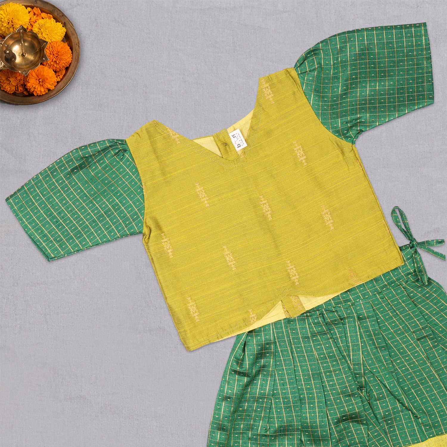 Girls green ethnic top and skirt set with cotton lining from Boon Babies, featuring traditional patterns and comfortable fabric.