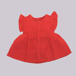 Baby girl crinkled muslin frill frock by Boon Babies, featuring a solid design with delicate frills and soft fabric.