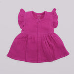 Baby girl crinkled muslin solid frill frock in magenta purple by Boon Babies, featuring ruffled sleeves and a soft, comfortable design.