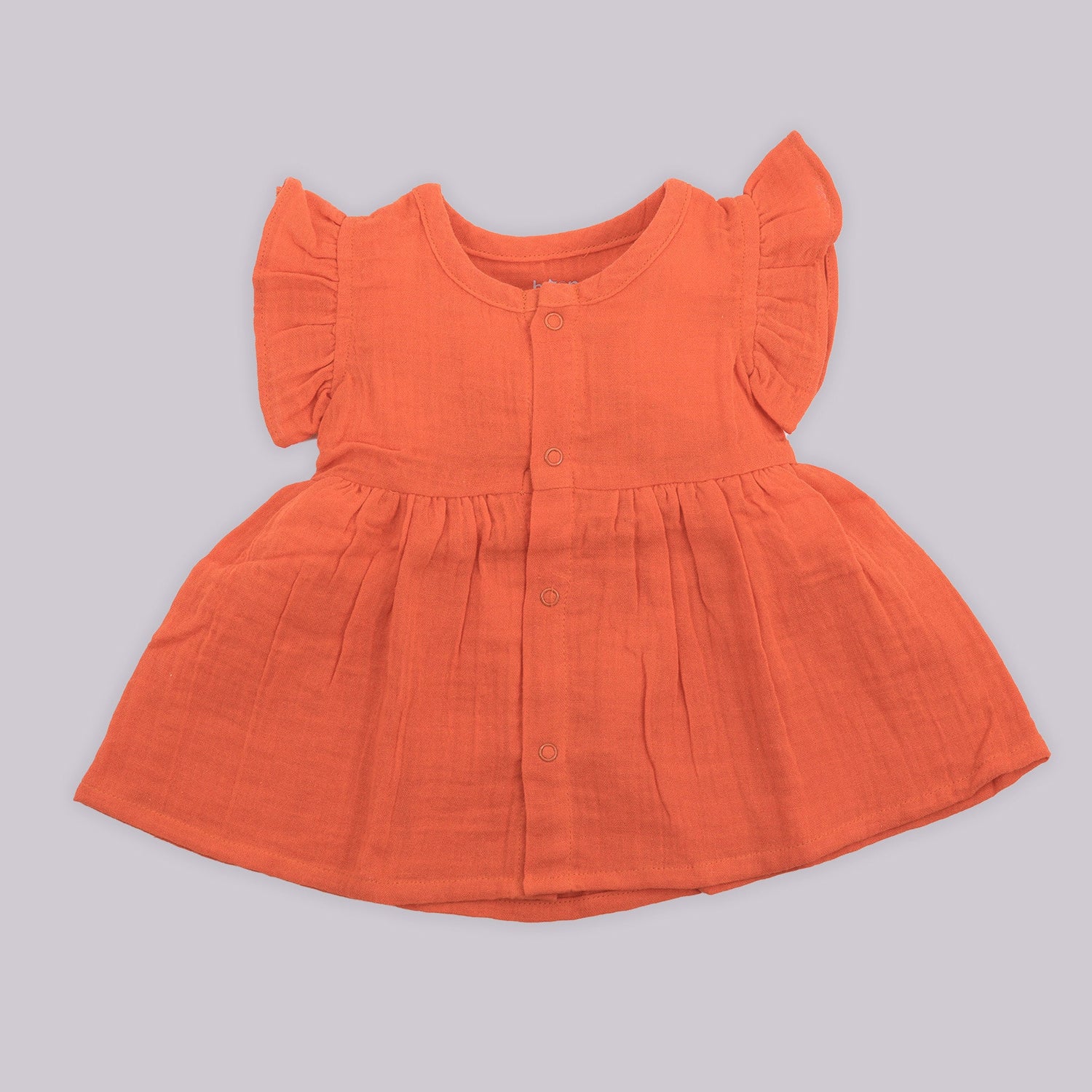 Solid rust orange crinkled muslin frill frock for baby girls.