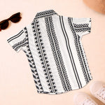 Boy wearing a black and white printed cotton casual shirt with straight collar from boonbabies, featuring half sleeves and a stylish design.