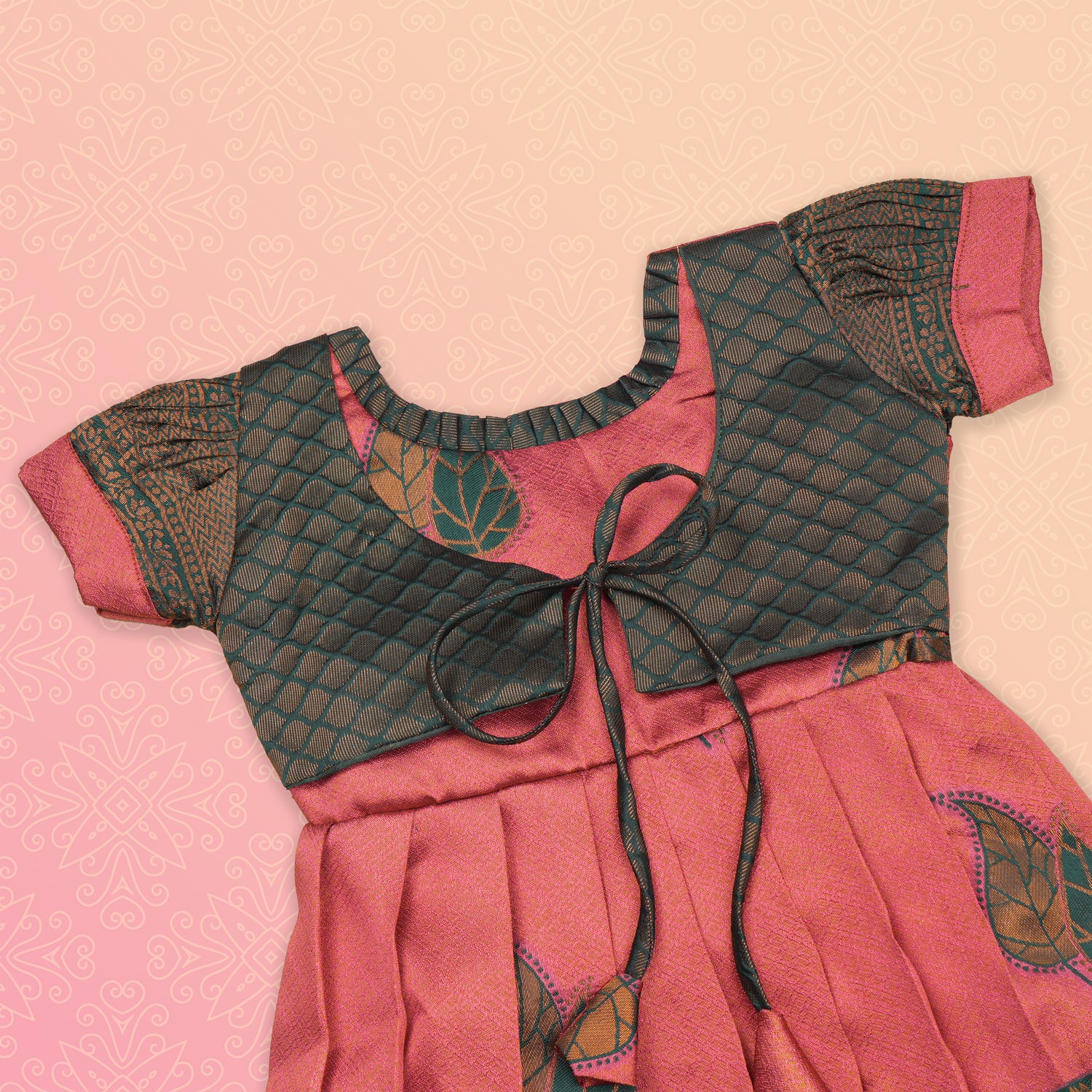 Girls' peach and green tissue silk Pattu Pavadai ethnic frock by Boon Babies with intricate traditional embroidery.