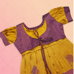 Girls' ethnic Pattu frock in mustard purple by Boon Babies, featuring traditional design and intricate fabric details.