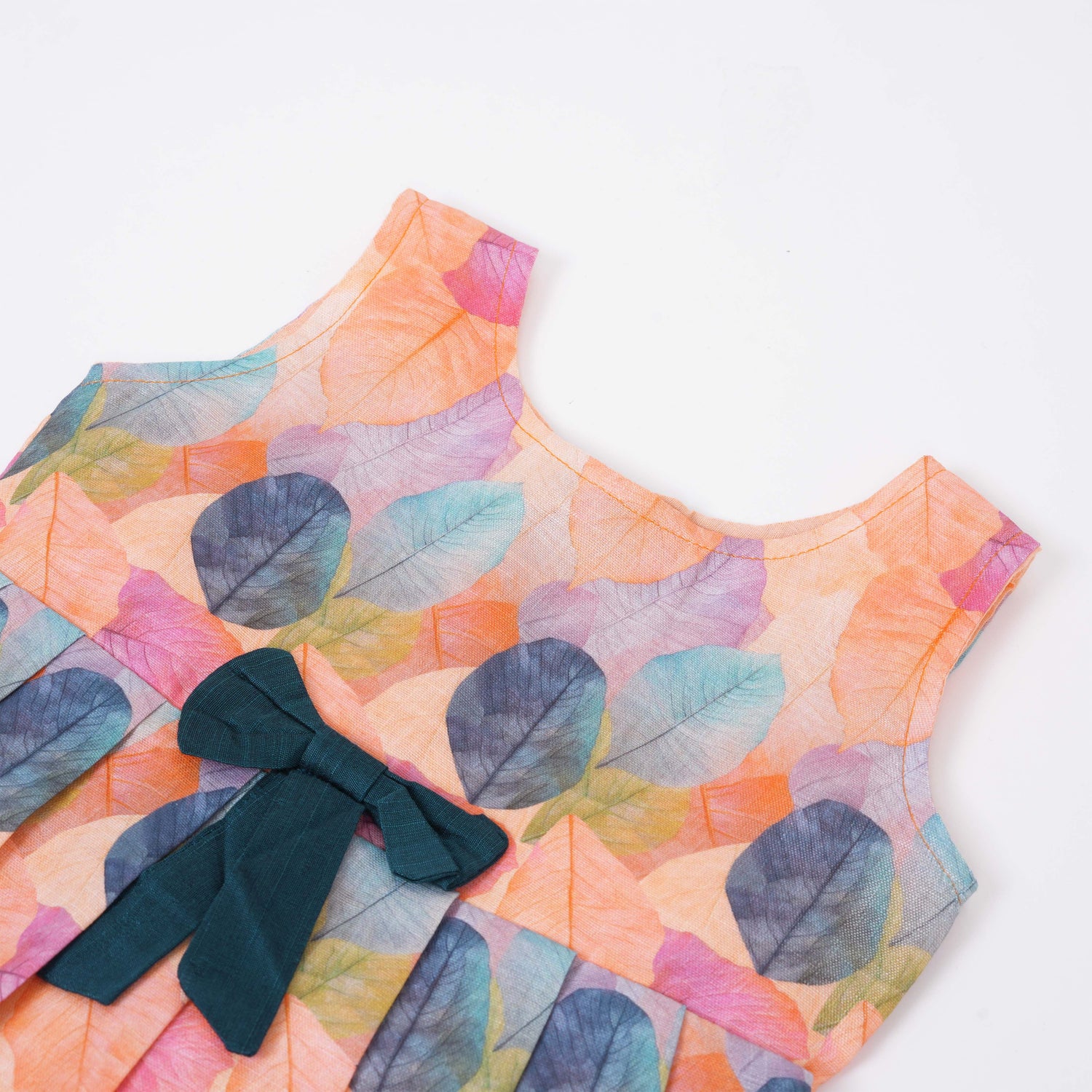 Colorful sleeveless cotton frock with multicolor leaf prints & bow. Ages 1–4 years. Perfect for festive outings, birthdays & everyday cuteness.