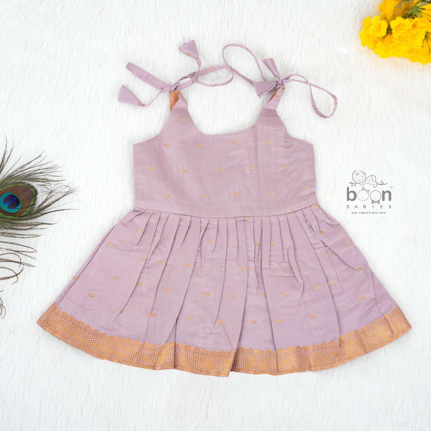 Lavender silk Onam knot frock with zari border & triangle yoke. Ages 0–12M. Perfect festive outfit for baby girls.
