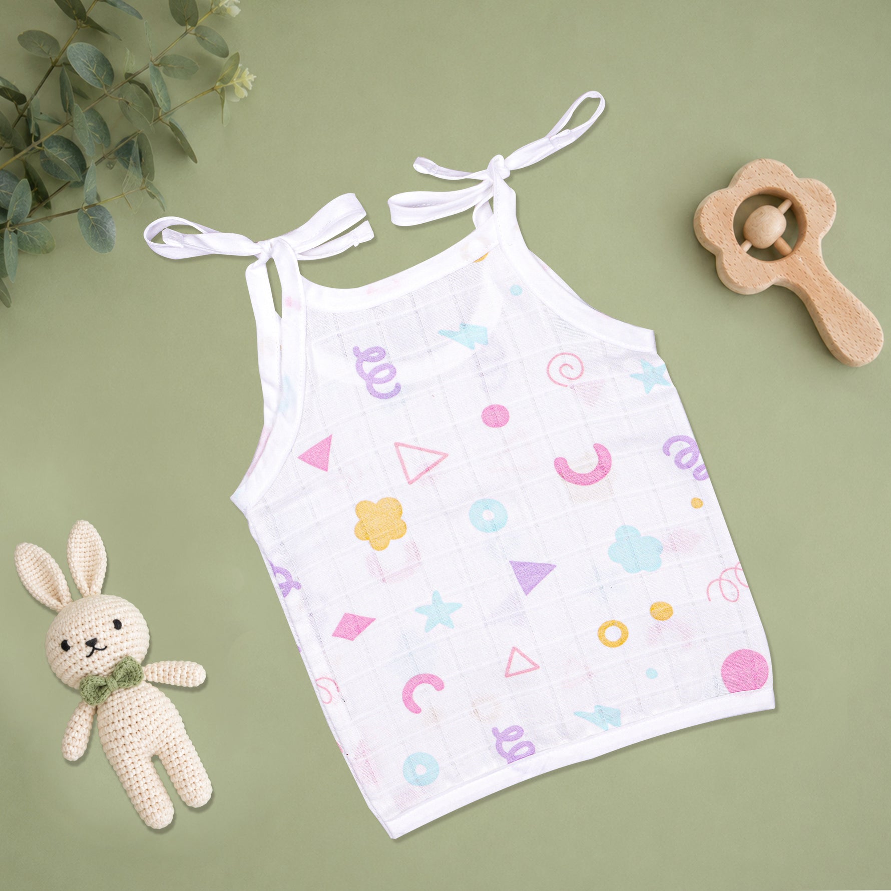 Soft printed Boonbabies muslin knot jabla for babies aged 0-6 months, featuring a tie-up design and gentle fabric.