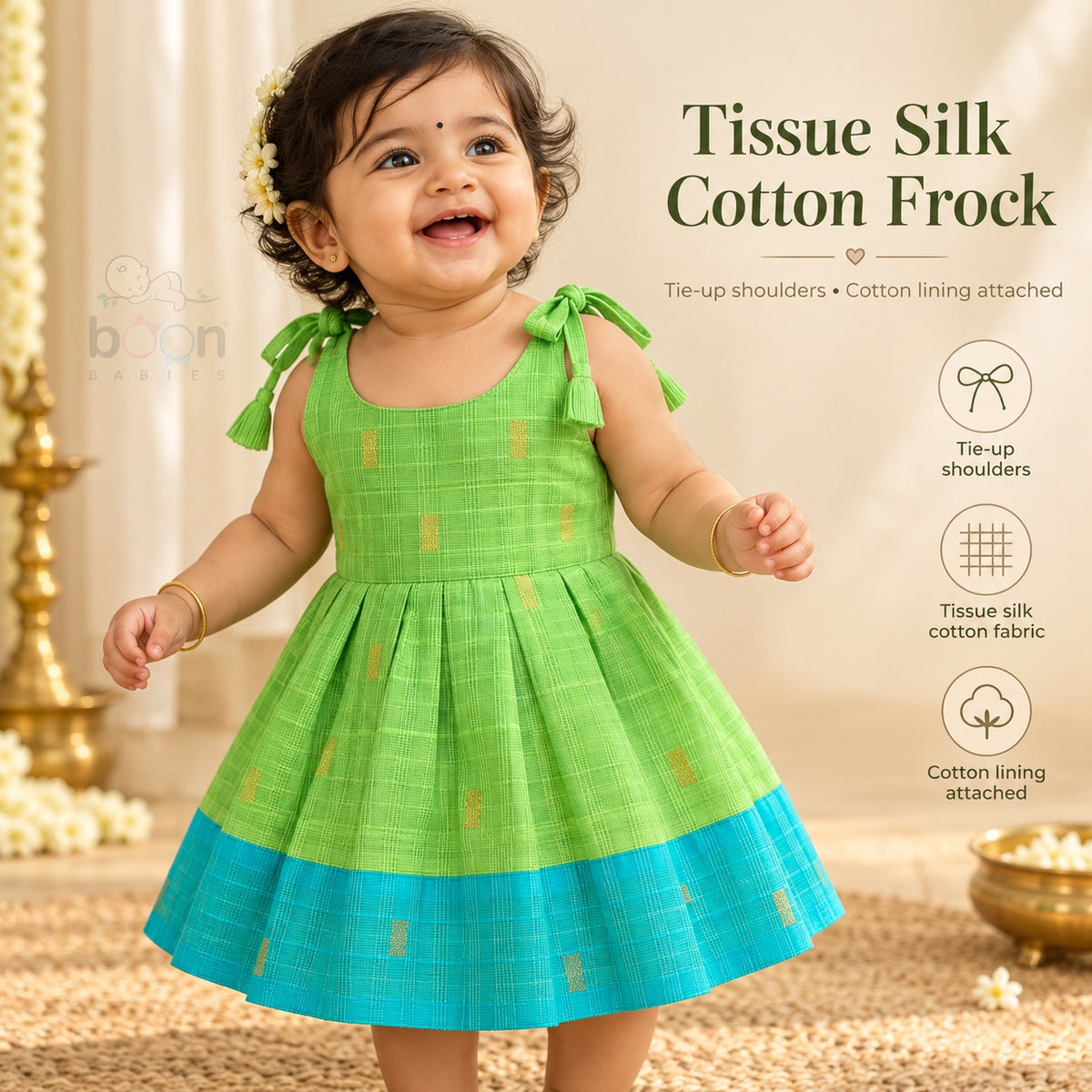 Baby girl wearing green tissue silk cotton knot frock with turquoise border and gold woven motifs