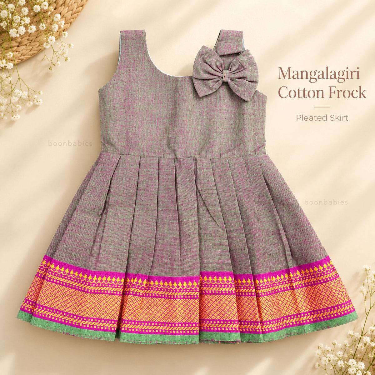 Baby girl grey Mangalagiri cotton frock front view with pleated skirt, shoulder bow and pink woven border