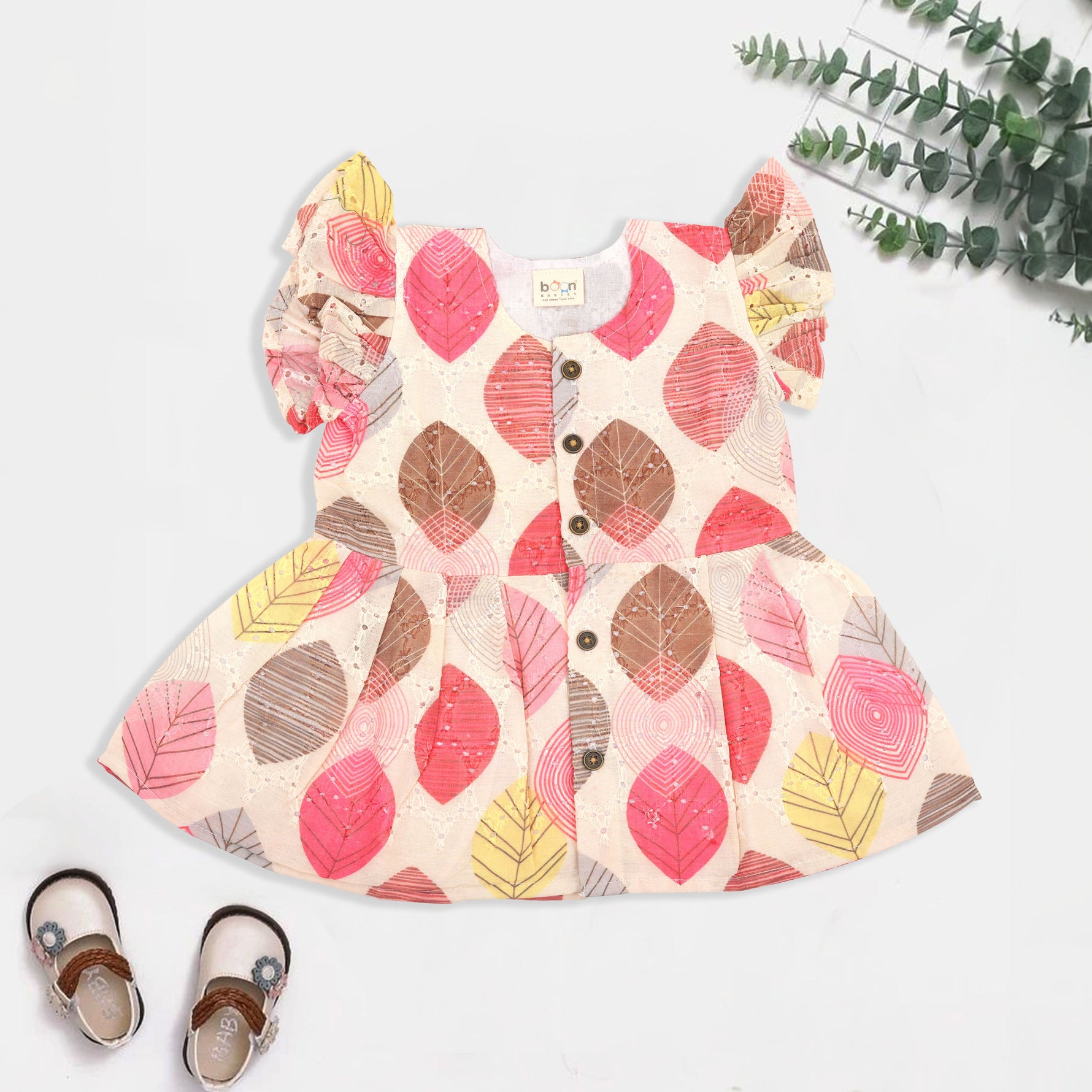 Baby girls hakoba frill frock with red & yellow leaf print (NB–24M). Soft cotton, frill sleeves & button closure – festive & everyday ready.