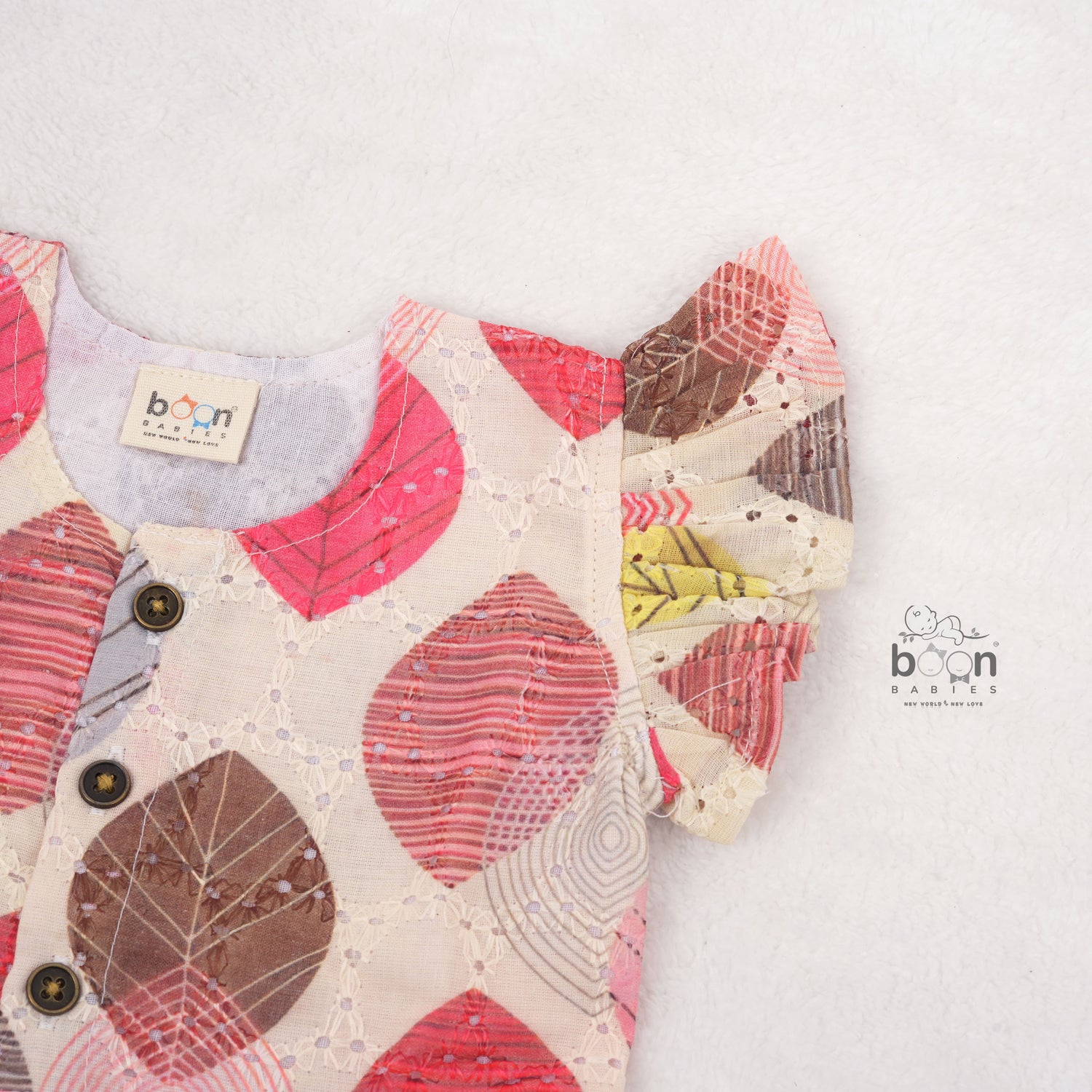 Baby girls hakoba frill frock with red & yellow leaf print (NB–24M). Soft cotton, frill sleeves & button closure – festive & everyday ready.