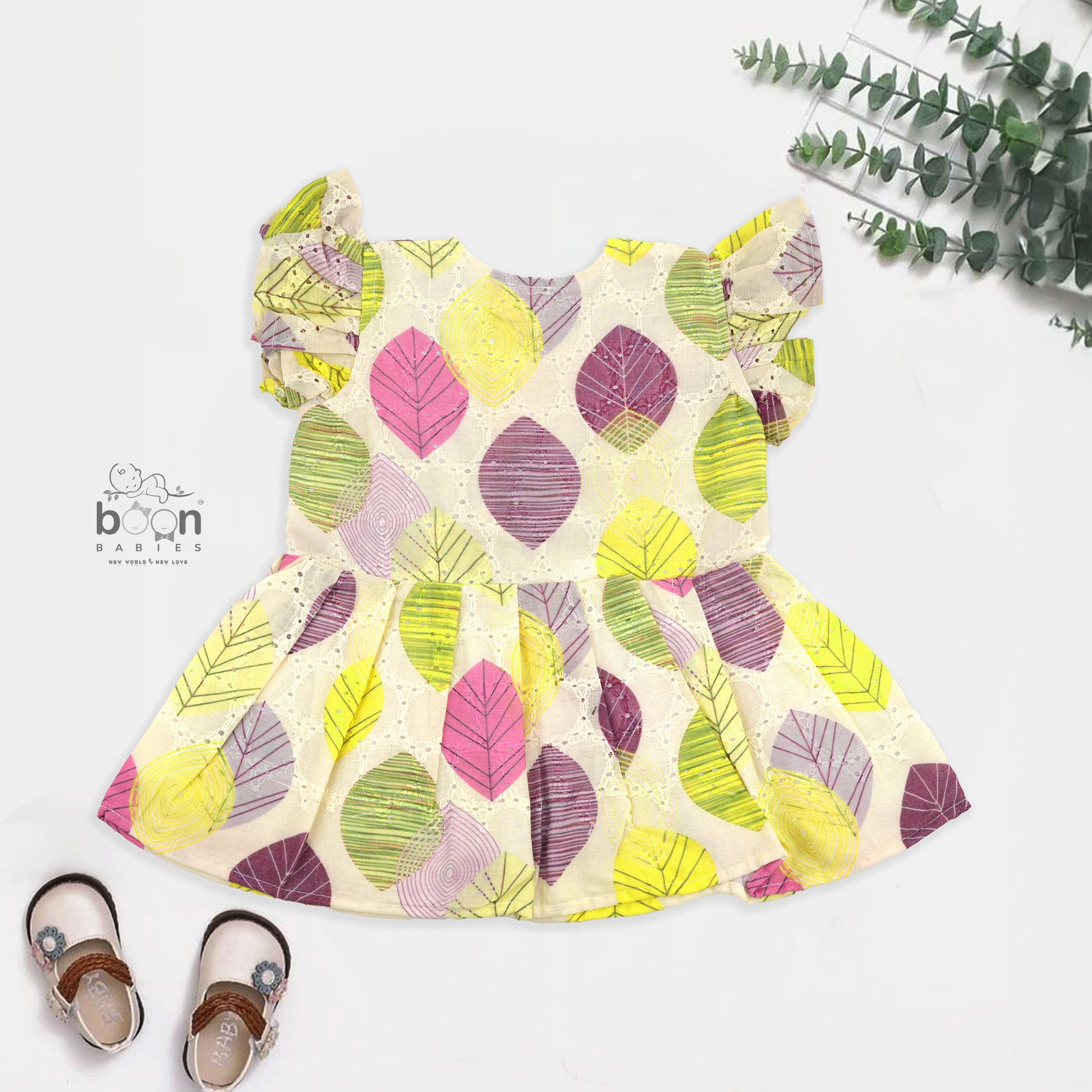 Baby girls hakoba frill frock with leaf print in yellow, purple & pink (NB–24M). Soft cotton, frill sleeves & button-down style – comfy & stylish.