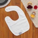 Breathable muslin baby bib with leafy print and snap closure. Skin-friendly and perfect for daily mess-free moments.