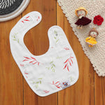 Breathable muslin baby bib with leafy print and snap closure. Skin-friendly and perfect for daily mess-free moments.