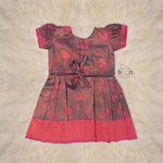 Traditional silk ethnic frock in Rani Pink and Brown for girls aged 1 to 5 years. Features zari motifs and puff sleeves – ideal for weddings and festivals.