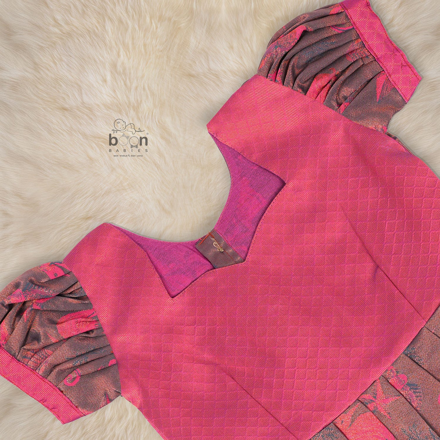 Traditional silk ethnic frock in Rani Pink and Brown for girls aged 1 to 5 years. Features zari motifs and puff sleeves – ideal for weddings and festivals.