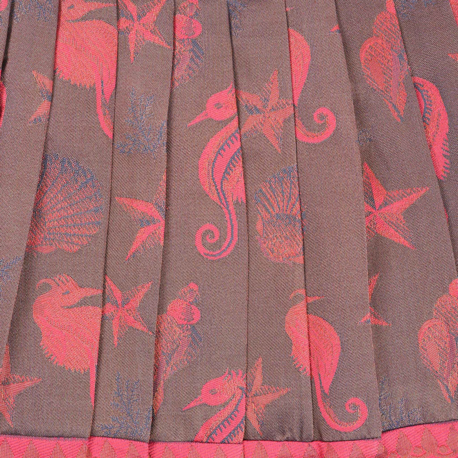 Traditional silk ethnic frock in Rani Pink and Brown for girls aged 1 to 5 years. Features zari motifs and puff sleeves – ideal for weddings and festivals.