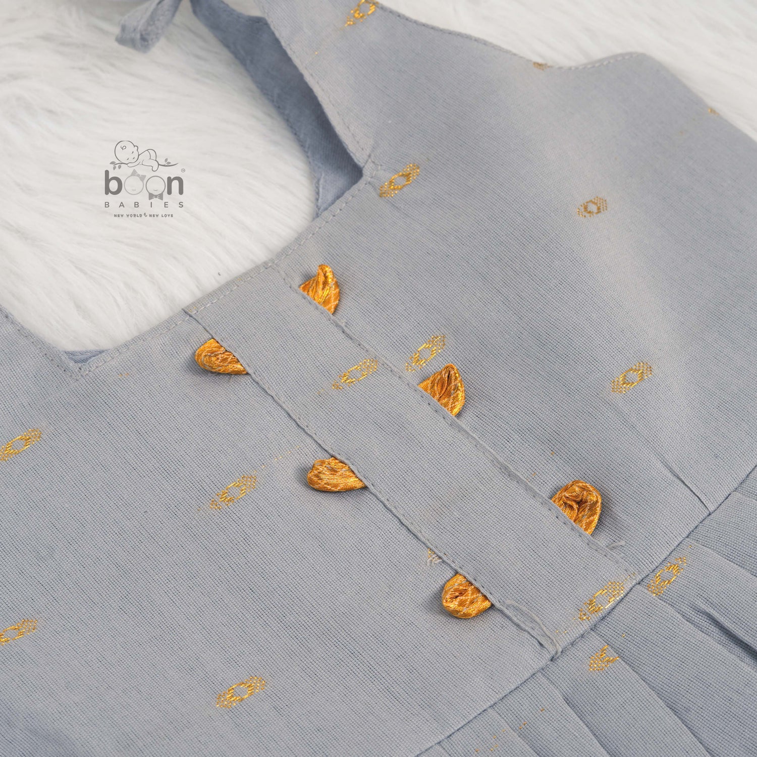 Grey silk knot frock with zari border & pleated design for baby girls (0–12 months). Stylish, festive & comfortable.
