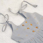 Grey silk knot frock with zari border & pleated design for baby girls (0–12 months). Stylish, festive & comfortable.
