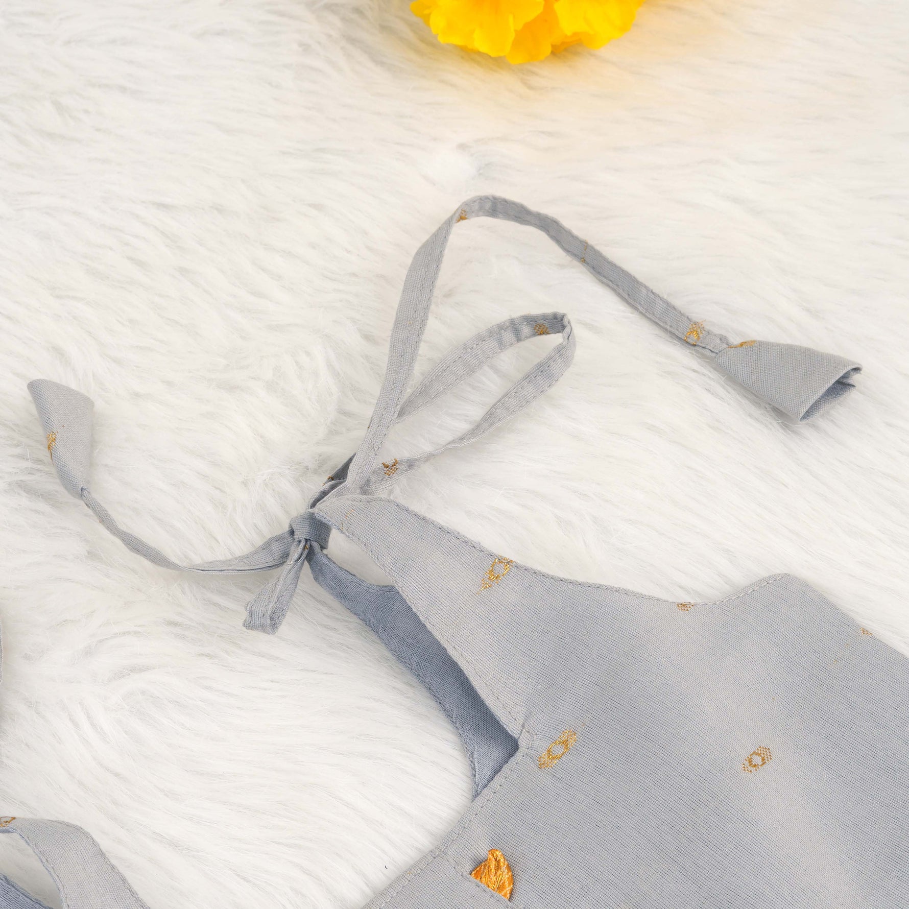 Grey silk knot frock with zari border & pleated design for baby girls (0–12 months). Stylish, festive & comfortable.
