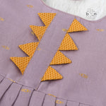 Lavender silk Onam knot frock with zari border & triangle yoke. Ages 0–12M. Perfect festive outfit for baby girls.