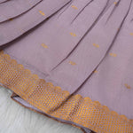 Lavender silk Onam knot frock with zari border & triangle yoke. Ages 0–12M. Perfect festive outfit for baby girls.