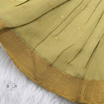 Olive green silk Onam knot frock with zari border & triangle yoke. Ages 0–12M. Perfect festive outfit for baby girls.