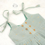 Festive silk knot frock for baby girls (6–12 months) with zari border & tie-up straps. Perfect for Onam & traditional celebrations.
