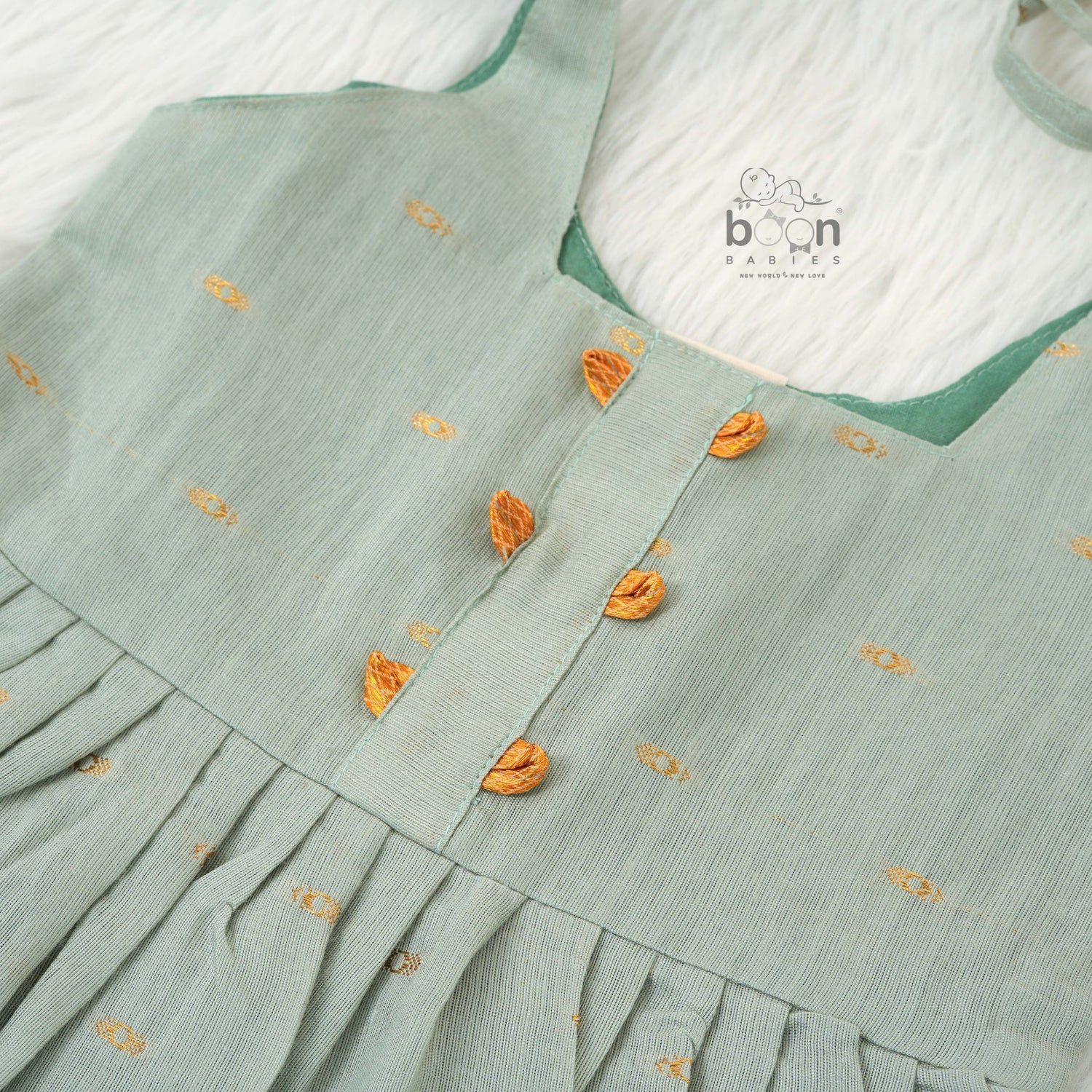 Festive silk knot frock for baby girls (6–12 months) with zari border & tie-up straps. Perfect for Onam & traditional celebrations.
