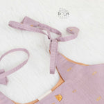 Elegant mauve silk knot frock with zari border for baby girls (0–12 months). Festive & comfortable – perfect for Onam celebrations.