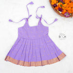 Festive purple silk Onam knot frock with triangle yoke design & zari border. Perfect for baby girls (0–12M).