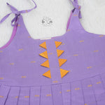 Festive purple silk Onam knot frock with triangle yoke design & zari border. Perfect for baby girls (0–12M).