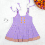 Festive purple silk Onam knot frock with triangle yoke design & zari border. Perfect for baby girls (0–12M).