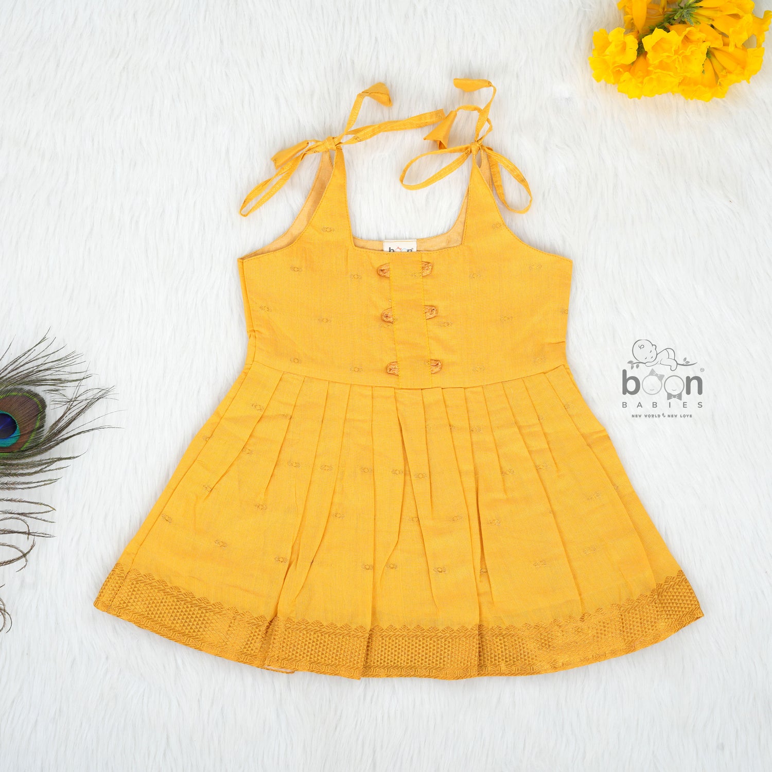 Mustard yellow silk knot frock with zari border for baby girls (6–12 months). Traditional, festive & comfortable.
