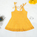 Mustard yellow silk knot frock with zari border for baby girls (0–12 months). Traditional, festive & comfortable.
