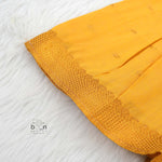 Bright yellow silk Onam knot frock with triangle yoke design & zari border. Perfect festive wear for baby girls (0–12M).