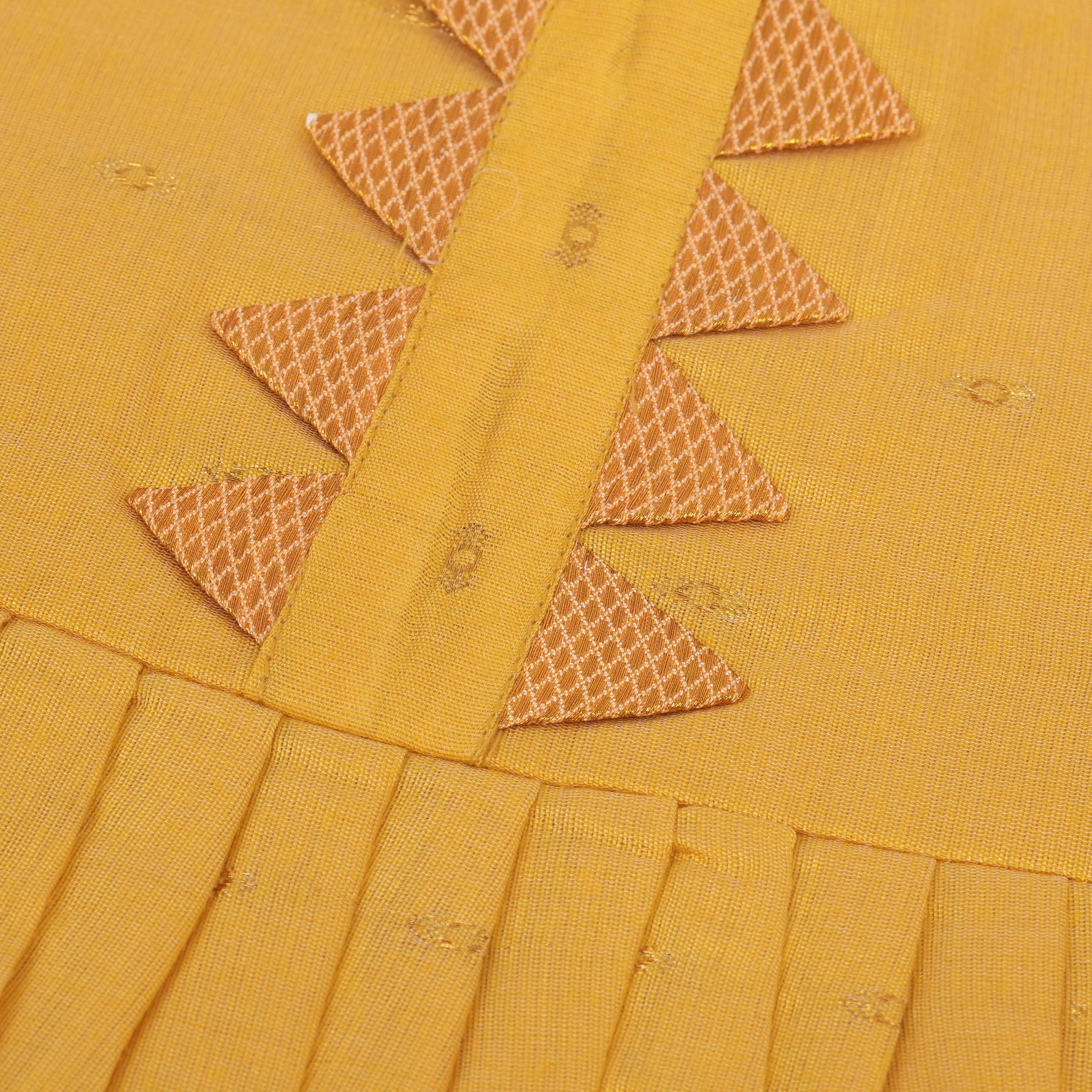 Bright yellow silk Onam knot frock with triangle yoke design & zari border. Perfect festive wear for baby girls (0–12M).