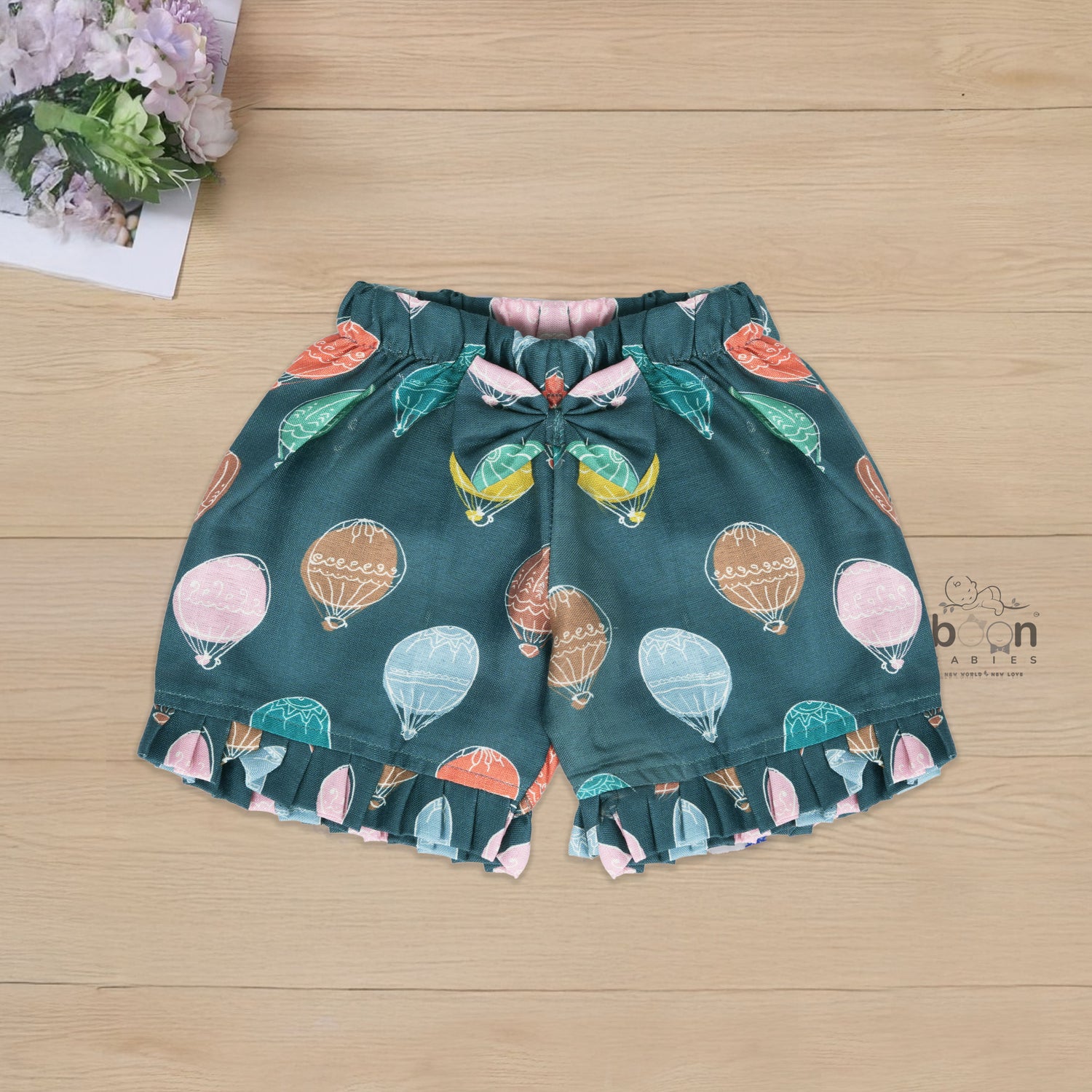Cotton frill top & shorts set with teal base and multicolor hot air balloon print. Sizes 6M–5Y. Cute, comfy & playful casual wear for girls.
