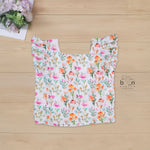 White cotton frill top with floral shorts. Ages 6M–5Y. Lightweight & stylish summer outfit for baby girls.
