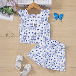 White cotton frill top & shorts set with blue reindeer print. Ages 6M–5Y. Cute, comfy & festive casual wear for baby girls