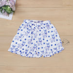 White cotton frill top & shorts set with blue reindeer print. Ages 6M–5Y. Cute, comfy & festive casual wear for baby girls