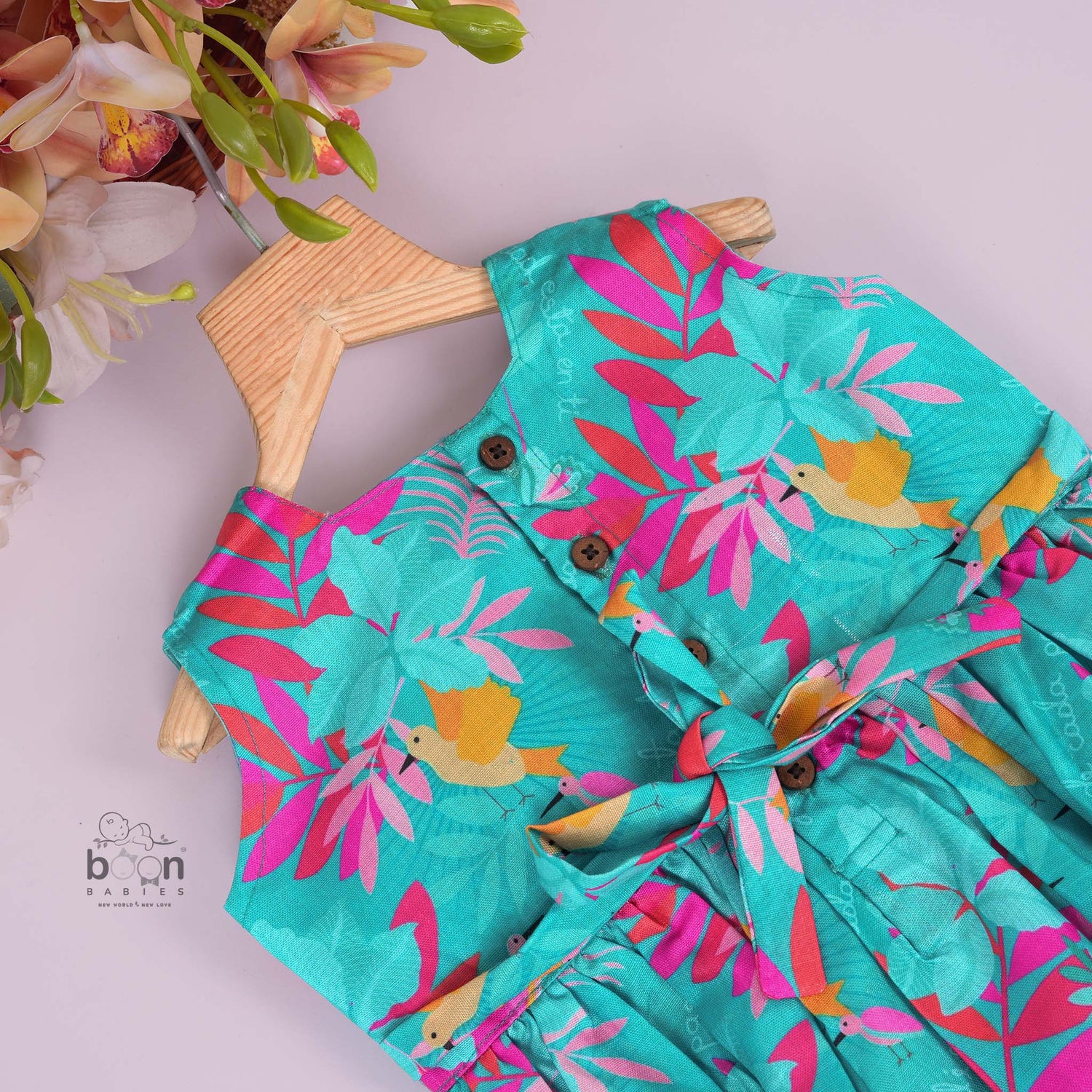 Aqua blue sleeveless frock for girls aged 1 to 4 years, made of slub cotton with colorful tropical bird and leaf print – from Boon Babies, Coimbatore.