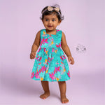 Aqua blue sleeveless frock for girls aged 1 to 4 years, made of slub cotton with colorful tropical bird and leaf print – from Boon Babies, Coimbatore.